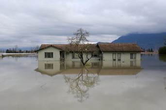 A home surrounded by floodwaters after rainstorms caused flooding and landslides in Chilliwack, British Columbia, in November 2021.
