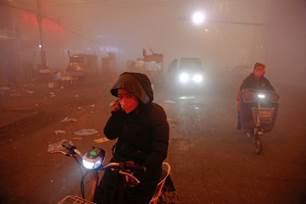 People on a smog-clouded street in Hebei Province, China, in 2016. China is the largest emitter of greenhouse gases, followed by the United States.